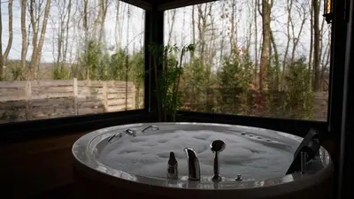 a bath tub in a room with a window at Pentalow Cabin in Kocaeli