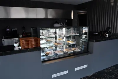 a display case with a bunch of pastries in it at Hmz LUXURY HOTEL in Çekmeköy