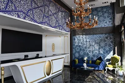 a living room with a tv and a chandelier at Hmz LUXURY HOTEL in Çekmeköy