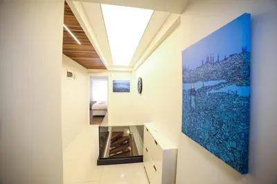 a room with a large painting on the wall at Modern Super Chic Duplex with a Terrace at the heart of city! in Istanbul