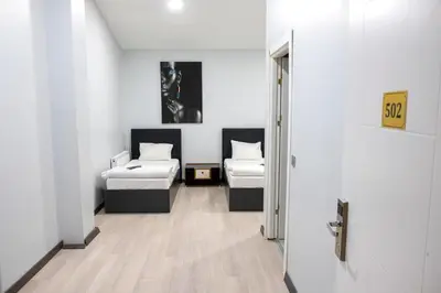a hallway with two beds in a room with a door at ZOOM HOTEL in Istanbul
