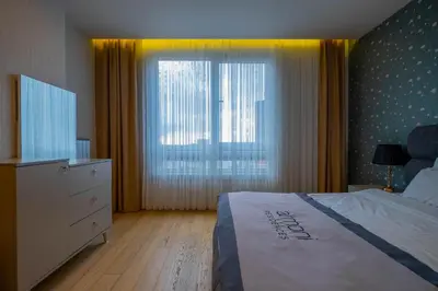 a bedroom with a bed and a dresser and a window at Ar-mo-ni in Istanbul