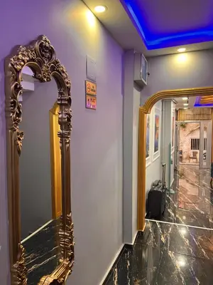 a gold mirror on a wall in a room at Sami hotel in Istanbul