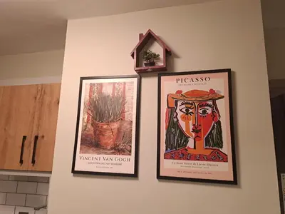 three framed posters hanging on a kitchen wall at Taksim Nida Flats in Istanbul