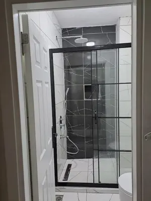 a bathroom with a shower with a glass door at Taksim Nida Flats in Istanbul