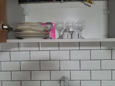 a shelf with plates and wine glasses on it at Taksim Nida Flats in Istanbul