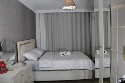 a small bedroom with a bed and a mirror at Solo Suites Hotel in Istanbul