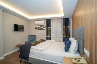 a hotel room with a bed and a desk and a chair at Hotel Martin in Istanbul