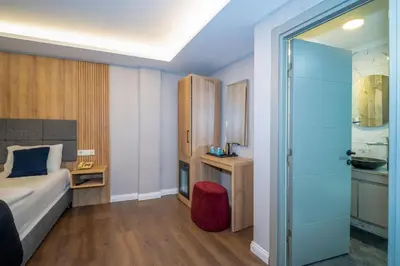 a hotel room with a bed and a sliding glass door at Hotel Martin in Istanbul