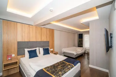 a hotel room with a bed and a television at Hotel Martin in Istanbul