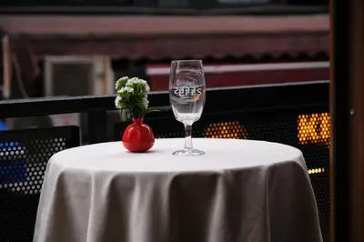 a wine glass and a vase on a table at Hotel Martin in Istanbul