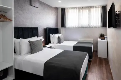 a hotel room with two beds and a window at İstanbul Efes Hotel in Istanbul