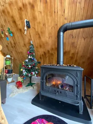 a fireplace in a room with a christmas tree at Yalova Kasaba Bungalov in Çınarcık