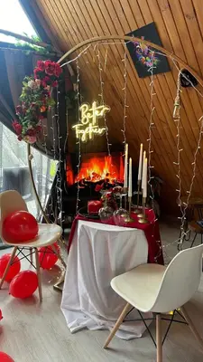a table and chairs in a room with a fireplace at Yalova Kasaba Bungalov in Çınarcık