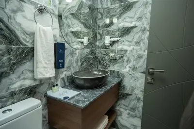 a bathroom with a sink and a bowl on a counter at Velmore Hotel & Spa in Kestel