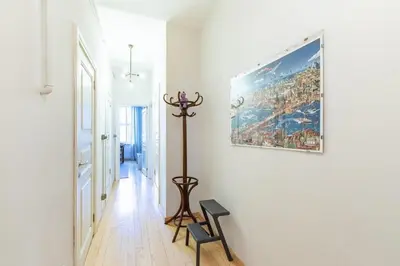 a hallway with a painting on the wall and a chair at Warm Cozy Charming 2BD2Bath GalataTower Gem! #256 in Istanbul