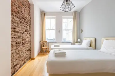 a bedroom with two beds and a brick wall at Warm Cozy Charming 2BD2Bath GalataTower Gem! #256 in Istanbul