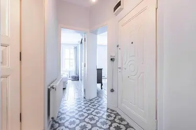 a hallway with a white door and a tile floor at Bright Charming 2BD15Bath GalataTower Home! #257 in Istanbul