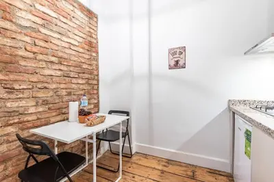 a white table and chairs in a kitchen with a brick wall at Bright Charming 2BD15Bath GalataTower Home! #257 in Istanbul