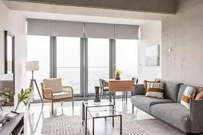 a living room with a couch and a table at Trendy Cool Bright Studio Parking PoolViews! #254 in Istanbul