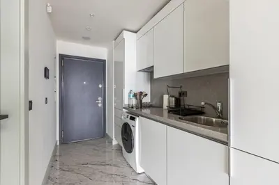 a white kitchen with a sink and a dishwasher at Trendy Cool Bright Studio Parking PoolViews! #254 in Istanbul
