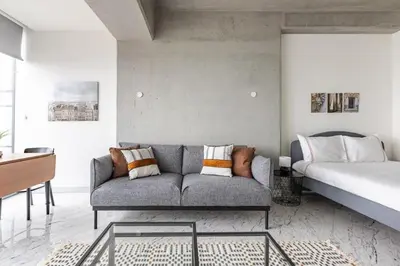 a living room with a couch and a bed at Trendy Cool Bright Studio Parking PoolViews! #254 in Istanbul