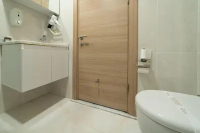 a bathroom with a toilet and a glass door at Mardy Hotel Ataturk Airport in Istanbul