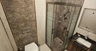 a bathroom with a shower and a toilet and a sink at Mardy Hotel Ataturk Airport in Istanbul