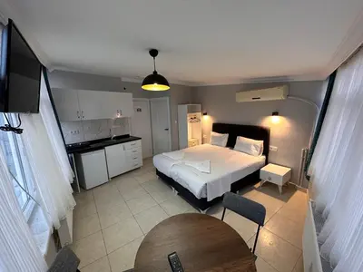 a bedroom with a bed and a table and a kitchen at Asparagus HOTEL & SUITES OLD CITY in Istanbul