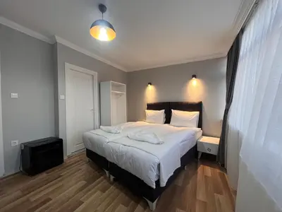 a bedroom with a large bed and a television at Asparagus HOTEL & SUITES OLD CITY in Istanbul