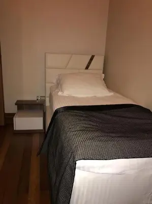 a bedroom with a bed and a side table at Aslan Residence in Istanbul