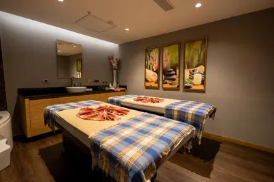 two beds in a bathroom with a sink and a mirror at Kate Hotel Special Class & SPA in Istanbul