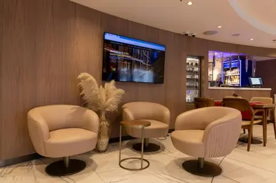 a waiting room with chairs and a tv on a wall at Kate Hotel Special Class & SPA in Istanbul