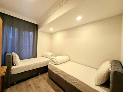 a room with two beds and a window at Halij suite in Istanbul