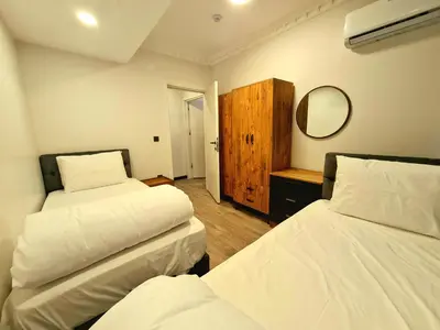 a bedroom with two beds and a mirror at Halij suite in Istanbul