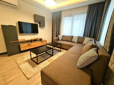a living room with a couch and a flat screen tv at Halij suite in Istanbul