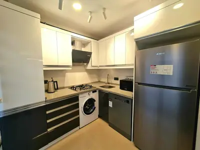 a kitchen with a stainless steel refrigerator and a dishwasher at Halij suite in Istanbul