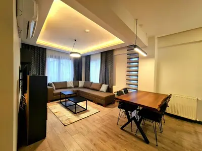 a living room with a table and a couch at Halij suite in Istanbul