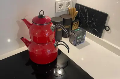a red tea kettle sitting on a kitchen counter at Cebeci Chic and Cosy Apartments in Istanbul