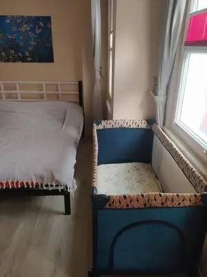 a bedroom with a bed and a bench next to a window at İstanbulda merkezi pitoresk konum müstakil yeni ev in Istanbul