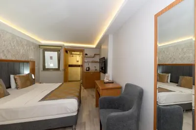 a hotel room with two beds and two chairs at GalataportWawhotel in Istanbul