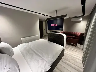a hotel room with a bed and a flat screen tv at BALA HOTEL in Tuzla