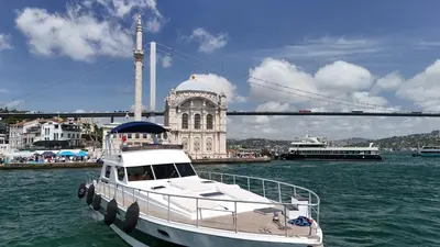 a boat is docked in the water near a bridge at PRUVA YACHT in Istanbul