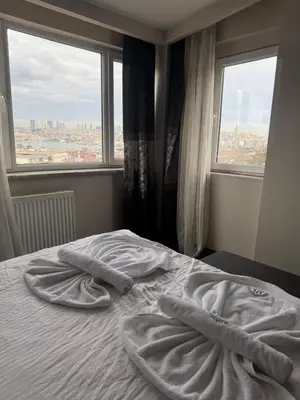 a bed with towels on it in a room with a window at Mar Boutique Apartment in Istanbul