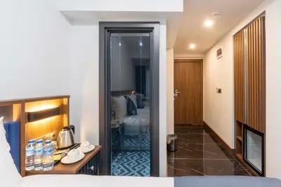 a hotel room with a bed and a walk in shower at THE BOSFOR HOTEL in Istanbul