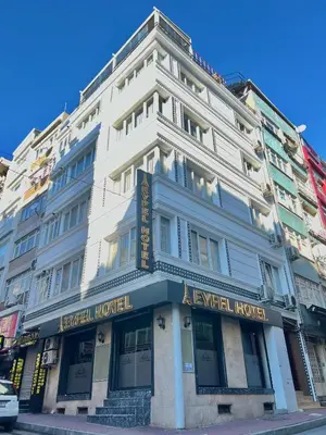a large white building on the corner of a street at EYFEL HOTEL in Istanbul