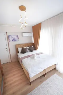 a bedroom with two beds and a chandelier at Two Bedroom King Deluxe Suite IS9 in Esenyurt