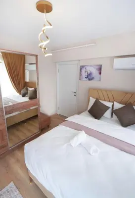 a bedroom with two beds and a mirror at Two Bedroom King Deluxe Suite IS9 in Esenyurt