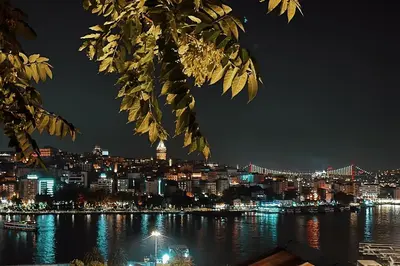 a view of a city at night from the water at The Haliç Bosphorus Hotel in Istanbul