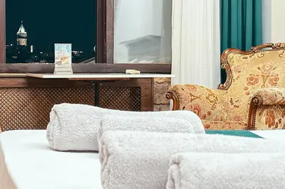 a room with a bed and a chair and a table at The Haliç Bosphorus Hotel in Istanbul